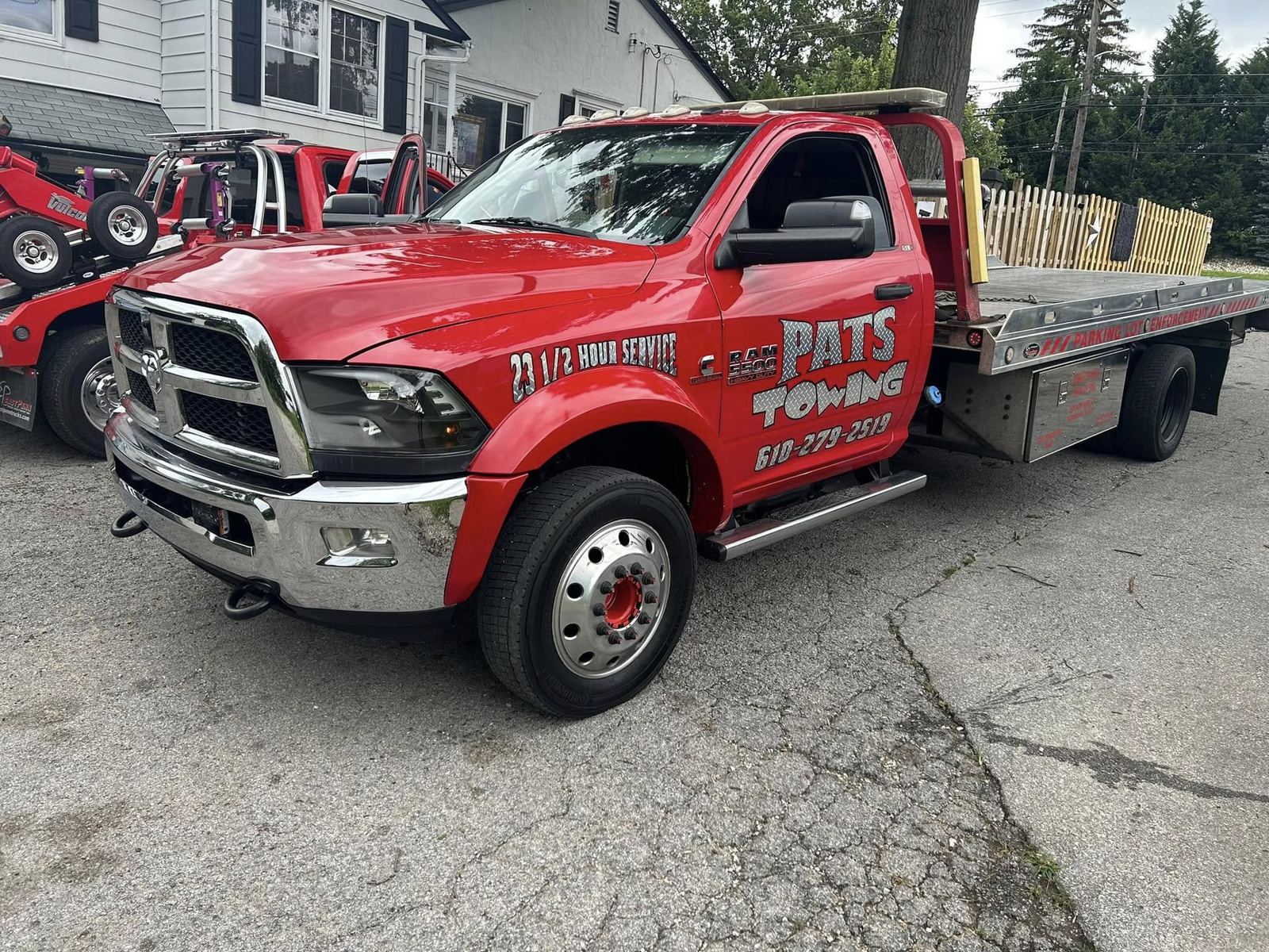 Pat's Towing red flatbed tow truck