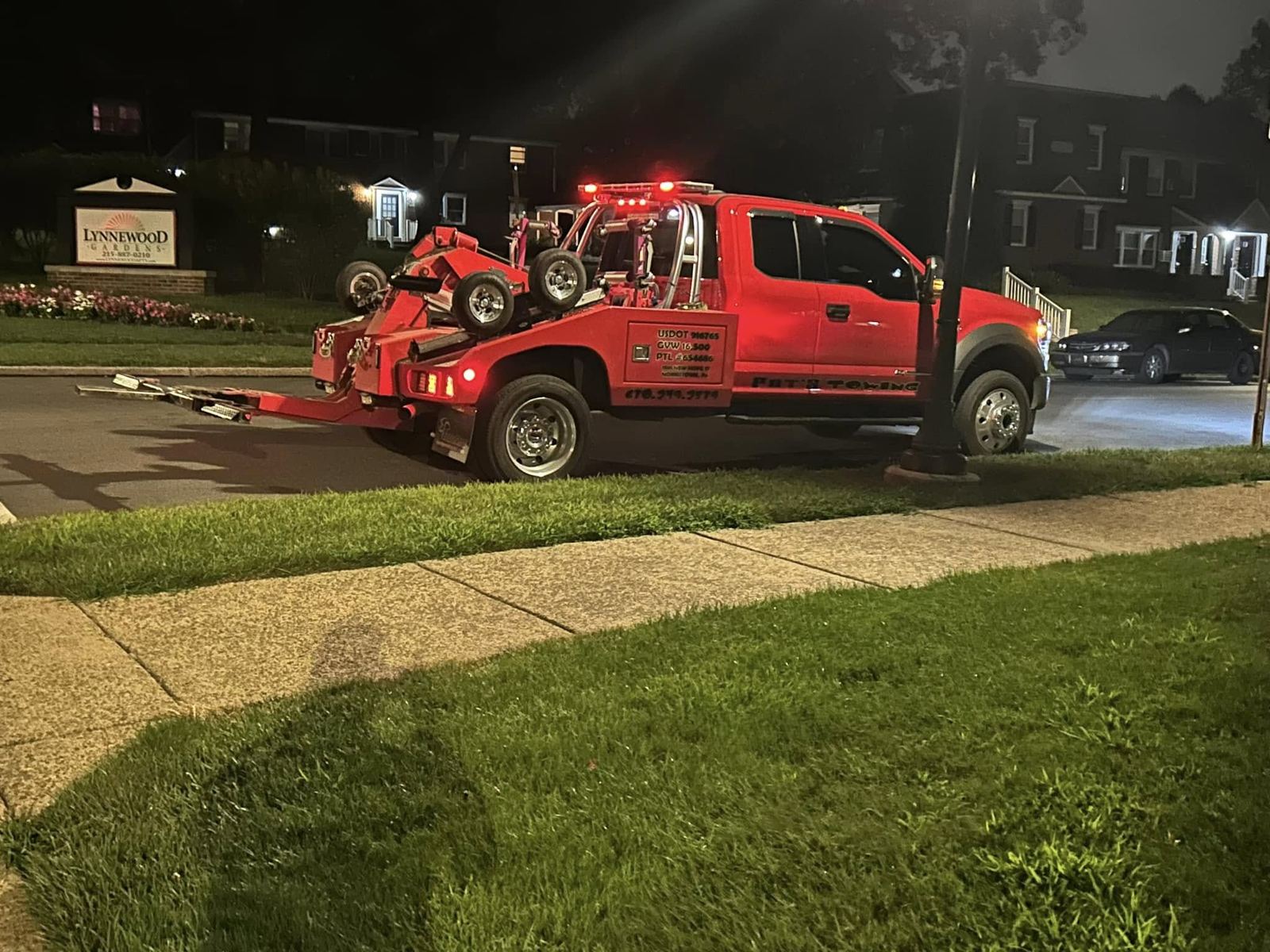 Pat's Towing at Lynwood Gardens apartment complex at night